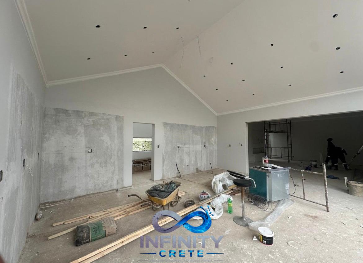 Before — open-plan living, dining and kitchen area prior to seamless screed flooring installation by Infinity Crete